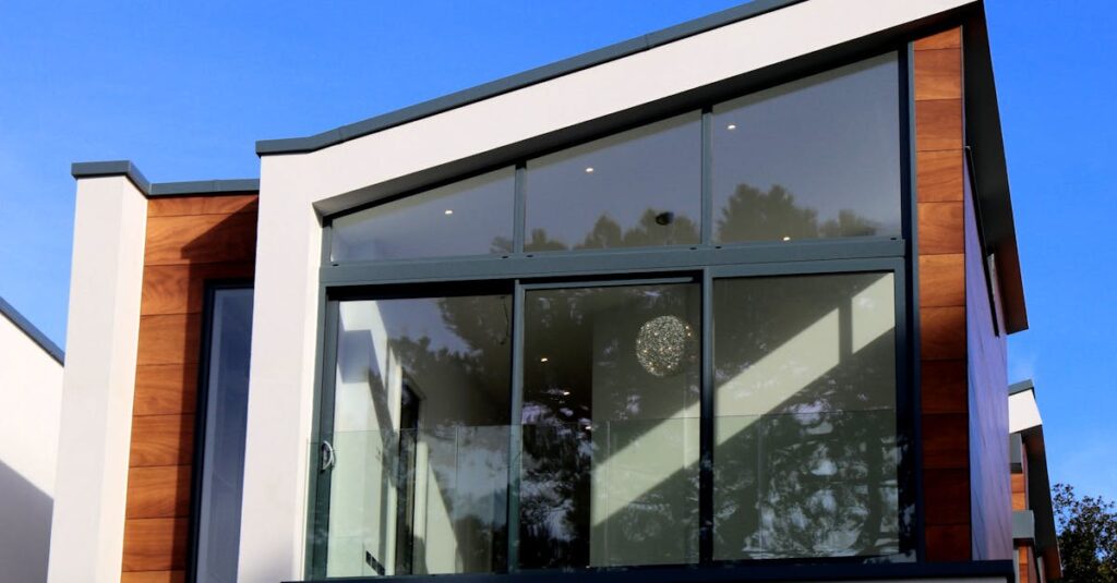 Contemporary house in Poole, UK featuring a sleek design with large glass windows and wood paneling.