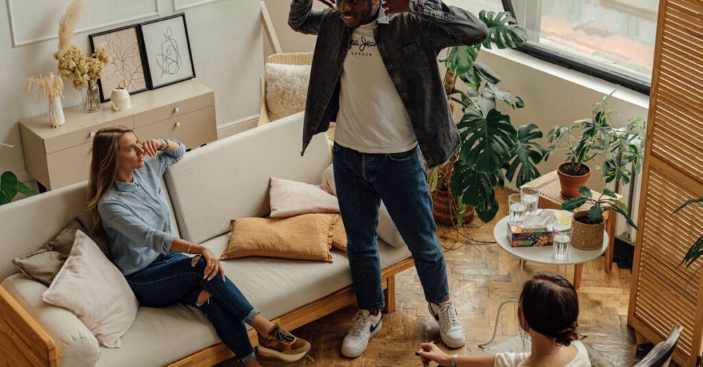 Three adults conversing in a stylish and cozy apartment living room setting.